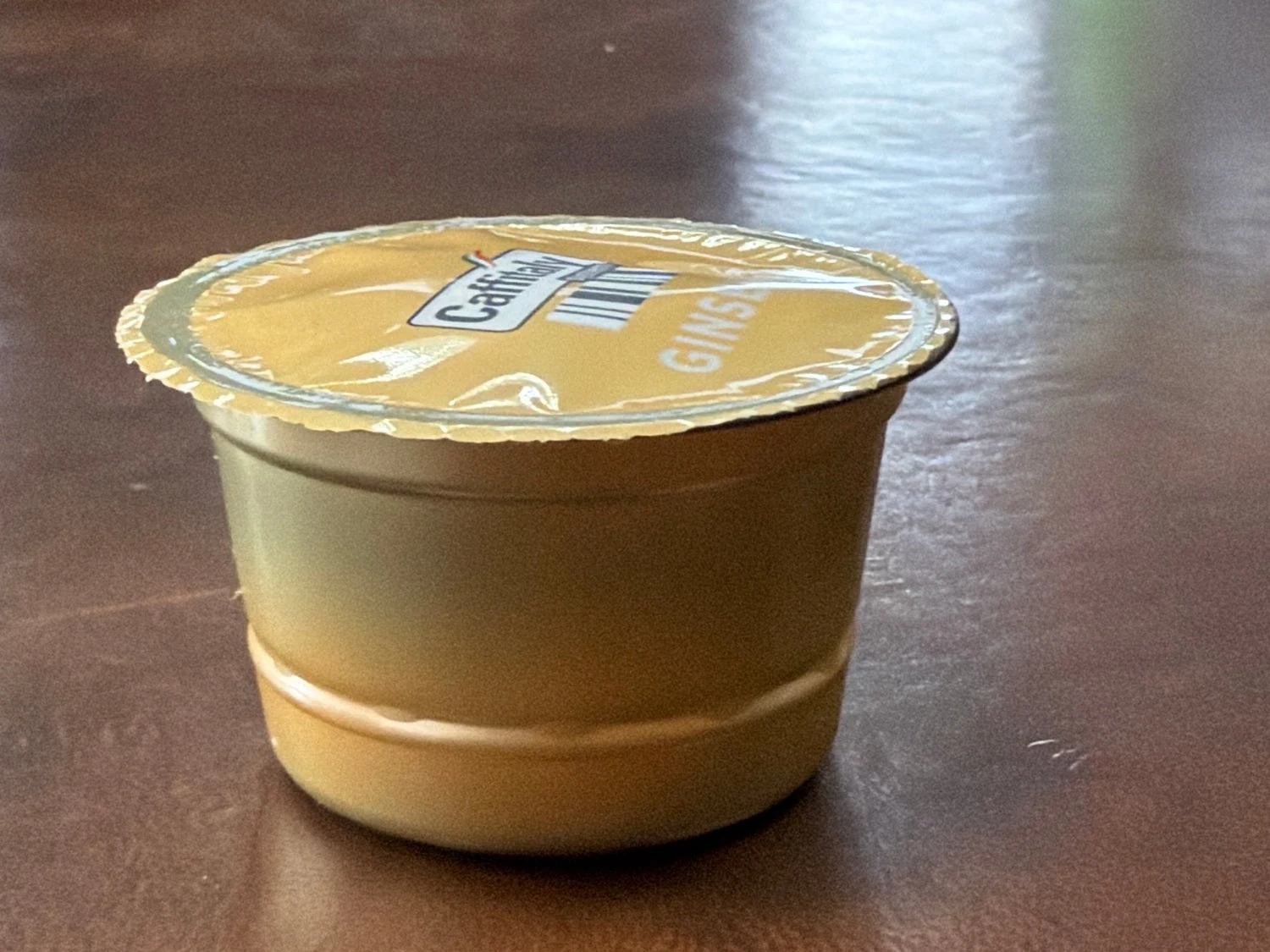 Actual Caffitaly Ginseng capsule showing the foil label and stepped body